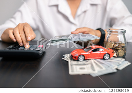 Finance bank tax expense accounting budget money businessman hand for Business expense analysis saving use car Financial calculate accountant close up calculator with graph chart write office desk 125898619