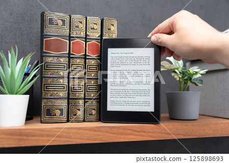 E-book reader device in home library 125898693