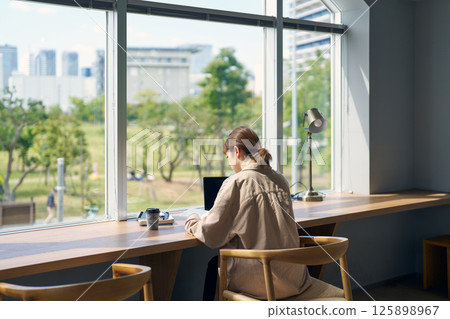 Woman studying in a coworking space Woman studying in a coworking space 125898967