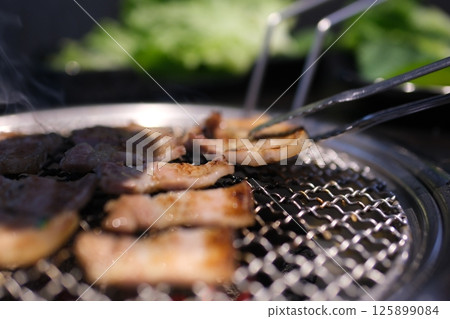 grill meat with lard thin Crispy golden grilled pork belly . 125899084
