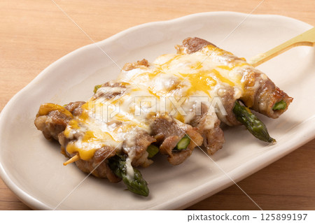 Asparagus wrapped in meat and cheese skewers Asparagus wrapped in meat and cheese skewers 125899197