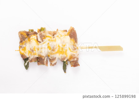 Asparagus wrapped in meat and cheese skewers 125899198
