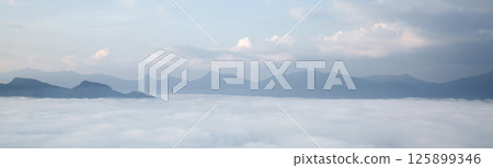Mountain landscape. foggy morning. High angle view of trees in forest during foggy weather. Beautiful mountain and cloud natural landscape at sunrise in Thailand. panoramic banner with copy space. Mountain landscape. foggy morning. High angle view of trees in forest during foggy weather. Beautiful mountain and cloud natural landscape at sunrise in Thailand. panoramic banner with copy space. 125899346
