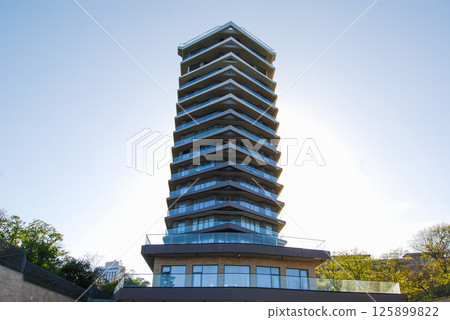 Multi-storey hotel complex. A modern multi-storey building with a unique architectural design, with multi-tiered corner balconies. Multi-storey hotel complex. A modern multi-storey building with a unique architectural design, with multi-tiered corner balconies. 125899822