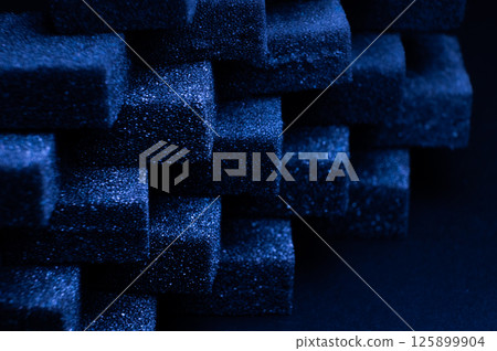 Blue Cubes of flexible foam sponges laid out in a pattern. Macro close-up in soft focus. Abstract cubic background 125899904