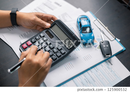 Finance bank tax expense accounting budget money businessman hand for Business expense analysis saving use car Financial calculate accountant close up calculator with graph chart write office desk 125900532