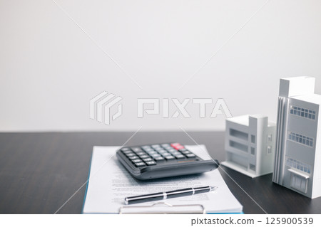 Finance bank tax expense accounting budget money businessman home for Business expense analysis saving use Financial calculate accountant close up calculator with graph chart hand write office desk 125900539