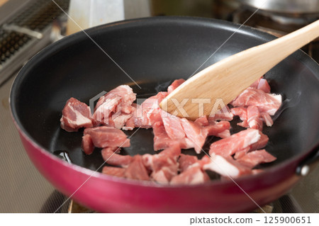 Shredded beef being fried in a frying pan (stock photo) 125900651
