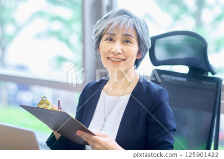 Senior business woman working at the office Senior business woman working at the office 125901422