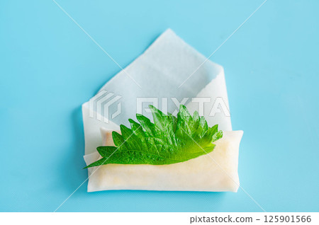 Deep-fried tofu, shiso leaves and cheese wrapped in spring roll skin 125901566