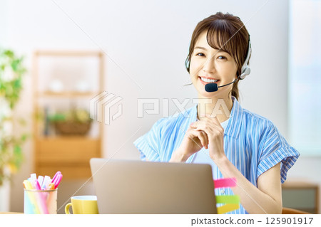 Operator during telework to chat at home using a personal computer Operator during telework to chat at home using a personal computer 125901917
