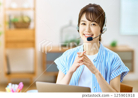 Operator during telework to chat at home using a personal computer Operator during telework to chat at home using a personal computer 125901918