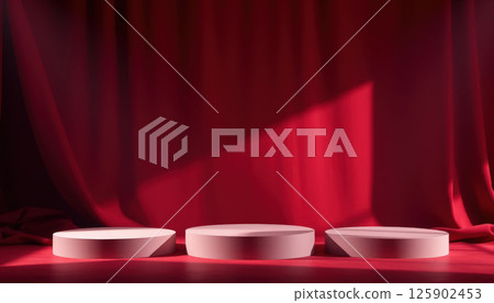dramatic red curtain backdrop with soft lighting highlights three white podiums of varying heights, creating stage like setting for presentations or displays. 125902453