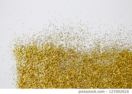 Gold glitters on a white background. Golden texture with glitter sparkles. Bright design for Banners, Greeting Gold Cards, Luxury Invitation, Certificate. Gold glitters on a white background. Golden texture with glitter sparkles. Bright design for Banners, Greeting Gold Cards, Luxury Invitation, Certificate. 125902628