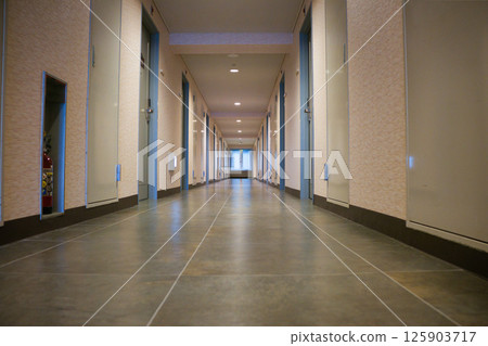 An empty hallway leading to the back of a building An empty hallway leading to the back of a building 125903717