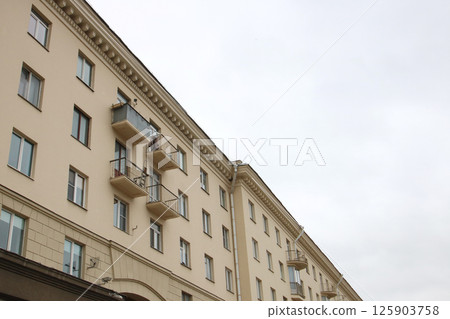 A beautiful balcony on a building with lovely arched windows A beautiful balcony on a building with lovely arched windows 125903758