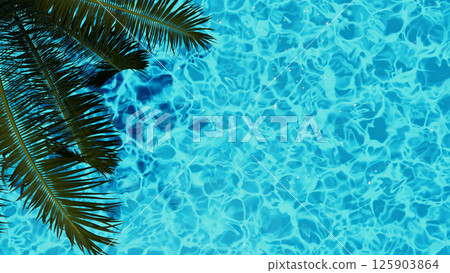 The inviting tropical pool water is enhanced by the lush green palm leaves around it 125903864