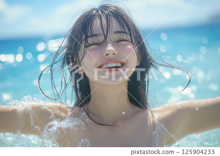 Joyful smiling young woman playing in the sea in summer 125904233