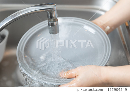 Image of hands washing dishes (stock photo) 125904249