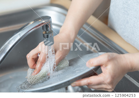 Image of hands washing dishes (stock photo) 125904253