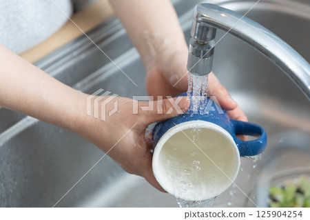Image of hands washing dishes (stock photo) 125904254