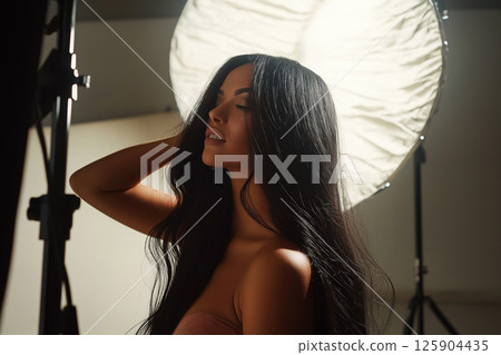 Glamorous woman posing in a professional photography studio with elegant lighting. Photosession, naked, nude, erotic modern portraits Glamorous woman posing in a professional photography studio with elegant lighting. Photosession, naked, nude, erotic modern portraits 125904435