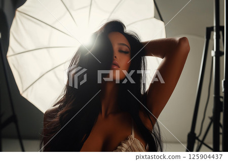 Glamorous woman posing in a professional photography studio with elegant lighting. Photosession, naked, nude, erotic modern portraits 125904437