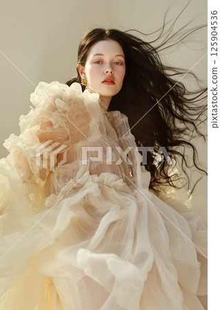 Stylish portrayal of a model featuring sophisticated vintage-inspired fashion and dynamic movement. Elegant woman in vintage styled attire with dramatic flowing accents 125904536