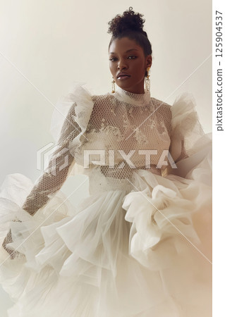 Stylish portrayal of a model featuring sophisticated vintage-inspired fashion and dynamic movement. Elegant woman in vintage styled attire with dramatic flowing accents 125904537