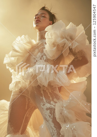 Stylish portrayal of a model featuring sophisticated vintage-inspired fashion and dynamic movement. Elegant woman in vintage styled attire with dramatic flowing accents 125904547