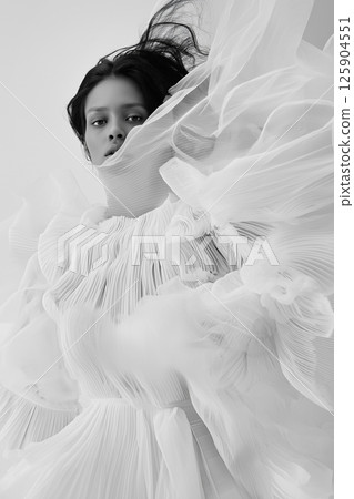 Stylish portrayal of a model featuring sophisticated vintage-inspired fashion and dynamic movement. Elegant woman in vintage styled attire with dramatic flowing accents Stylish portrayal of a model featuring sophisticated vintage-inspired fashion and dynamic movement. Elegant woman in vintage styled attire with dramatic flowing accents 125904551