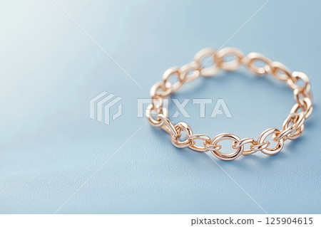Gold chain bracelet with braided design, representing elegance, luxury, and craftsmanship. Fashion and lux jewelry and accessories. 125904615