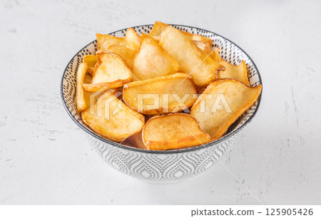 Golden potato dippers served hot in bowl, crispy edges and rustic feel Golden potato dippers served hot in bowl, crispy edges and rustic feel 125905426