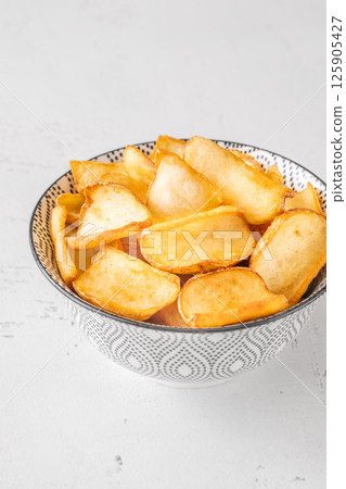 Golden potato dippers served hot in bowl, crispy edges and rustic feel Golden potato dippers served hot in bowl, crispy edges and rustic feel 125905427