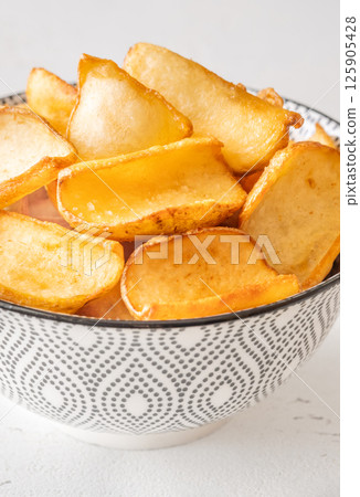 Golden potato dippers served hot in bowl, crispy edges and rustic feel Golden potato dippers served hot in bowl, crispy edges and rustic feel 125905428