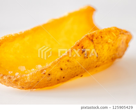 Single crispy potato dipper isolated against bright white background, fried to perfection Single crispy potato dipper isolated against bright white background, fried to perfection 125905429