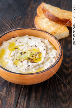 Creamy baba ghanoush in wooden bowl with chili and olive oil Creamy baba ghanoush in wooden bowl with chili and olive oil 125905439