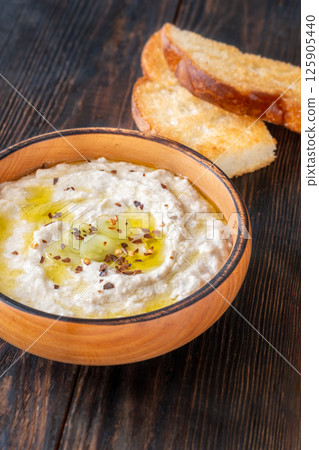 Creamy baba ghanoush in wooden bowl with chili and olive oil Creamy baba ghanoush in wooden bowl with chili and olive oil 125905440