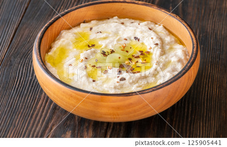 Creamy baba ghanoush in wooden bowl with chili and olive oil Creamy baba ghanoush in wooden bowl with chili and olive oil 125905441
