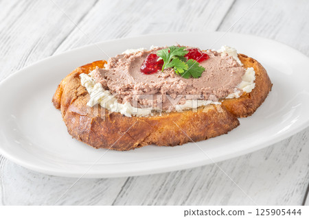 Gourmet sandwich layered with pate, cranberry jam, and cream cheese Gourmet sandwich layered with pate, cranberry jam, and cream cheese 125905444