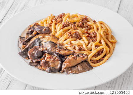 Unagi udon noodles served with beef and crispy garlic thyme shiitake 125905493