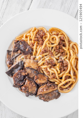 Unagi udon noodles served with beef and crispy garlic thyme shiitake Unagi udon noodles served with beef and crispy garlic thyme shiitake 125905494