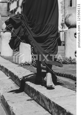 Barefoot Walk on Stone Path in Urban Landscape 125906131