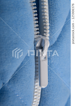 Zipper cashmere sweater macro. Fashionable blue jacket with a zipper for the cold season. Casual stylish clothes. Side plan. Zipper cashmere sweater macro. Fashionable blue jacket with a zipper for the cold season. Casual stylish clothes. Side plan. 125906376