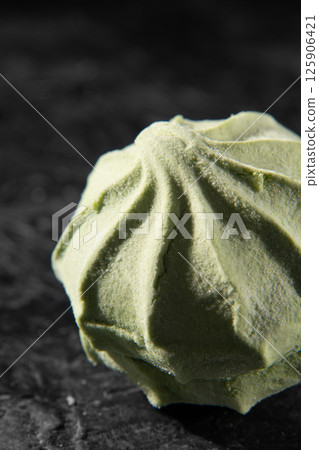 Natural marshmallow, green, apple on a black background close-up. 125906421