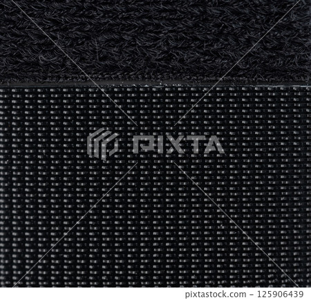 Black fabric texture with distinct weaving patterns showing close-up details and quality Black fabric texture with distinct weaving patterns showing close-up details and quality 125906439