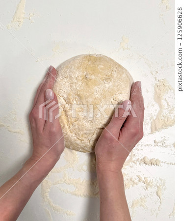Kneading dough with hands for baking fresh bread in a cozy kitchen setting healthy baking concept 125906628