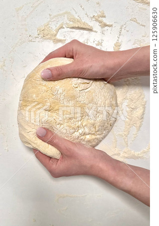 Kneading dough for baking bread in kitchen setting showcasing culinary skills and techniques concept 125906630