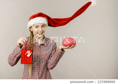Christmas woman holding shopping bag and brain 125906666