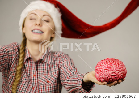 Happy woman wearing Santa Claus helper hat Happy woman wearing Santa Claus helper hat 125906668